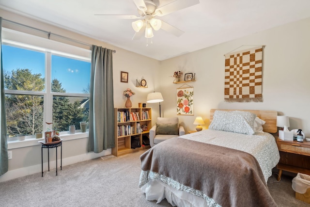 bedroom with baseboards, carpet floors, and a ceiling fan