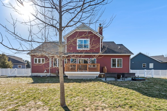 back of house with fence, a chimney, a deck, a yard, and a patio area