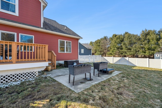 view of yard featuring a deck, a fenced backyard, and a patio area