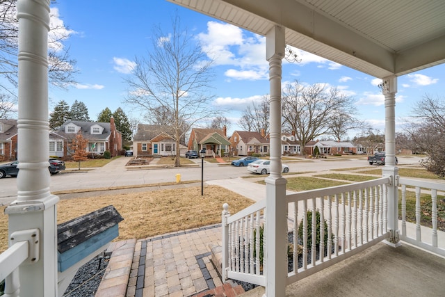 view of patio featuring covered porch and a residential view