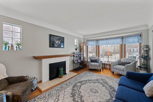 living area with wood finished floors, a fireplace, and a wealth of natural light