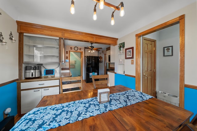 dining area with wood finished floors and ceiling fan