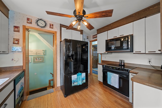 kitchen with white cabinetry, black appliances, and dark countertops