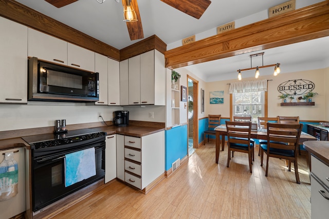 kitchen with visible vents, black appliances, dark countertops, white cabinetry, and light wood finished floors