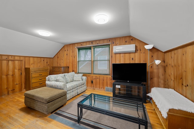 living room with visible vents, wooden walls, vaulted ceiling, and a wall mounted AC