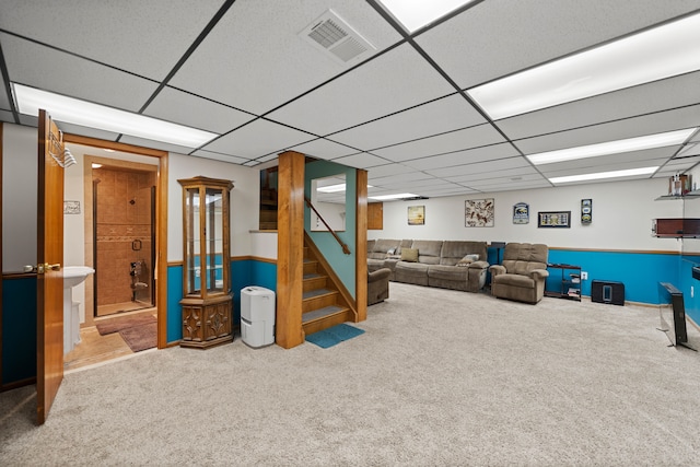 interior space with a paneled ceiling, visible vents, carpet floors, and stairway