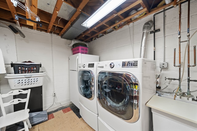 laundry room with tile patterned floors, laundry area, and independent washer and dryer