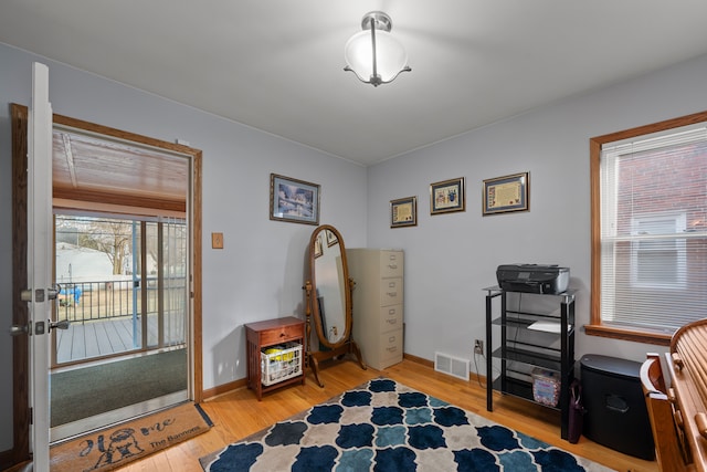 interior space with light wood finished floors, visible vents, and baseboards