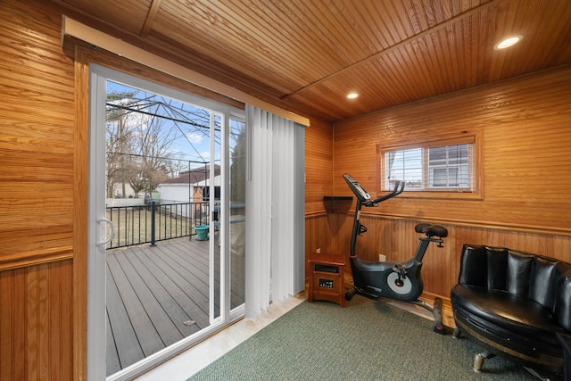 exercise room with plenty of natural light, wood ceiling, wood walls, and carpet floors