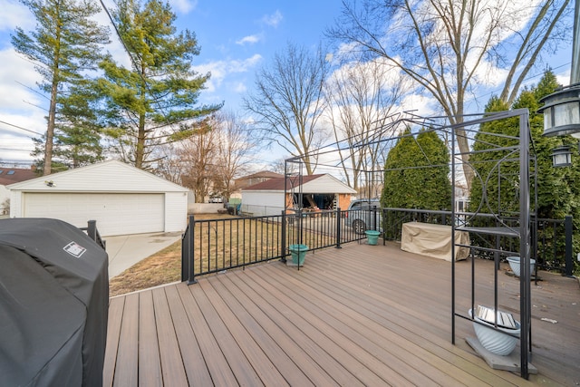 deck with a detached garage and an outbuilding