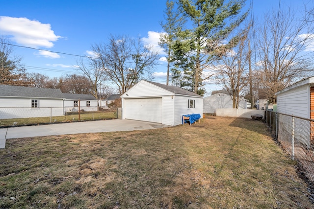 view of yard featuring a detached garage, an outbuilding, and a fenced backyard