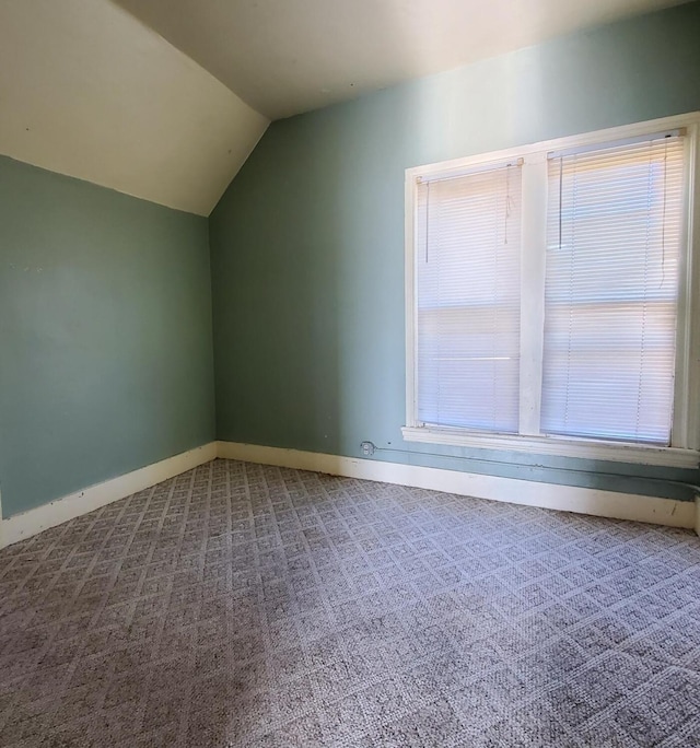 additional living space featuring vaulted ceiling, baseboards, and carpet floors