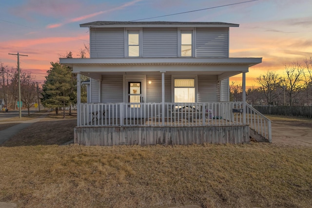 view of front of property featuring a yard and covered porch