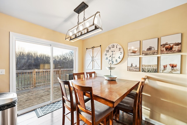 dining area with wood finished floors