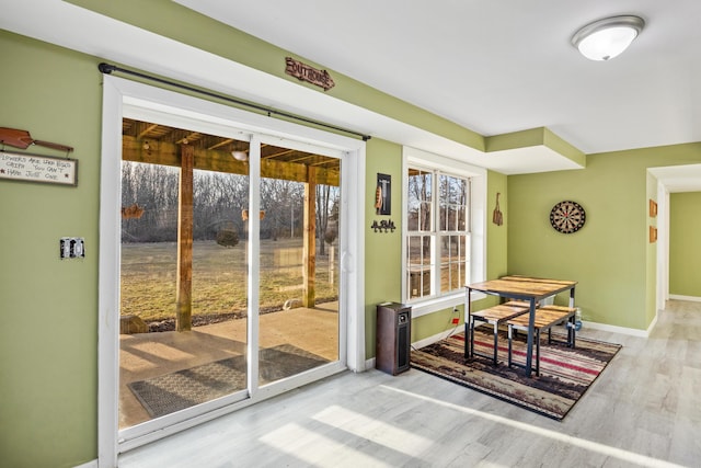 entryway featuring wood finished floors and baseboards