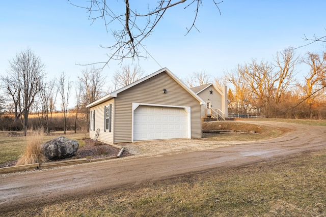 view of home's exterior featuring driveway and a chimney