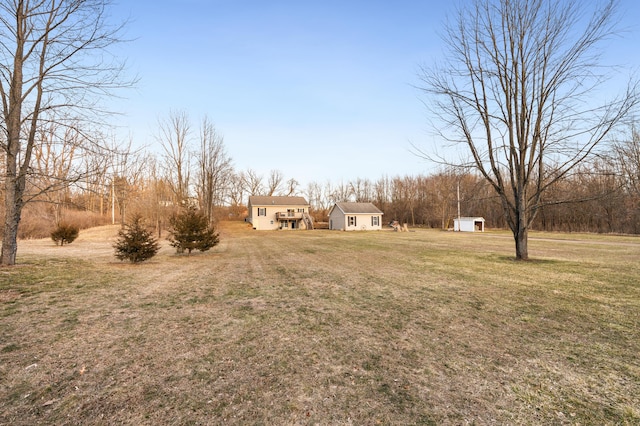 view of yard with an outbuilding and a storage shed