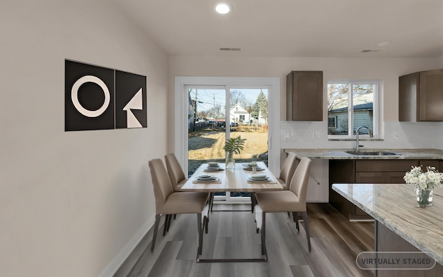 dining room featuring recessed lighting, visible vents, baseboards, and wood finished floors