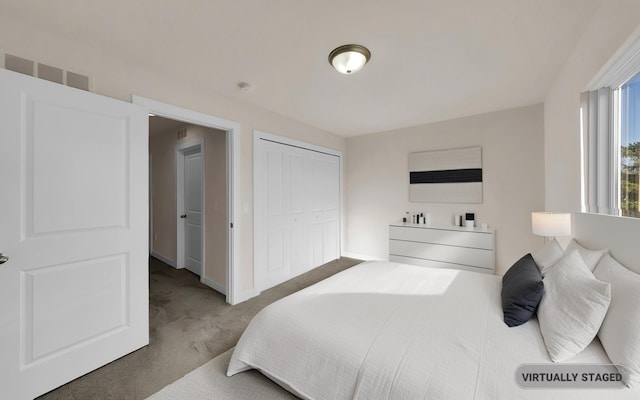 bedroom with carpet, visible vents, a closet, and baseboards