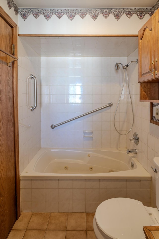 bathroom with tile patterned flooring, toilet, and tiled shower / bath combo