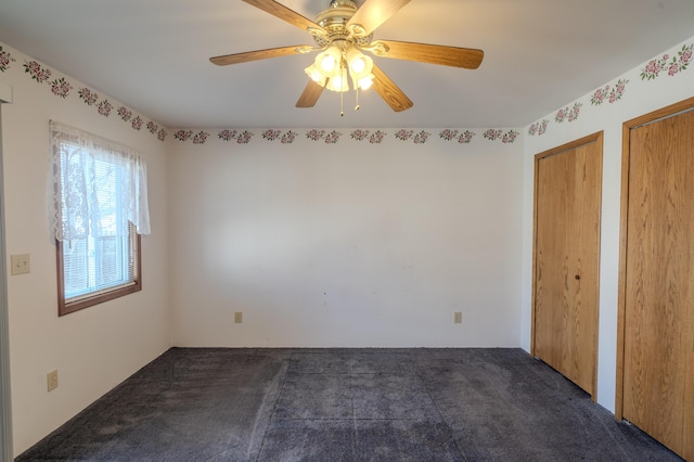 unfurnished bedroom with multiple closets, ceiling fan, and carpet flooring