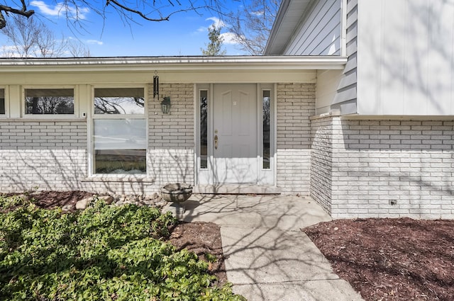 entrance to property with brick siding