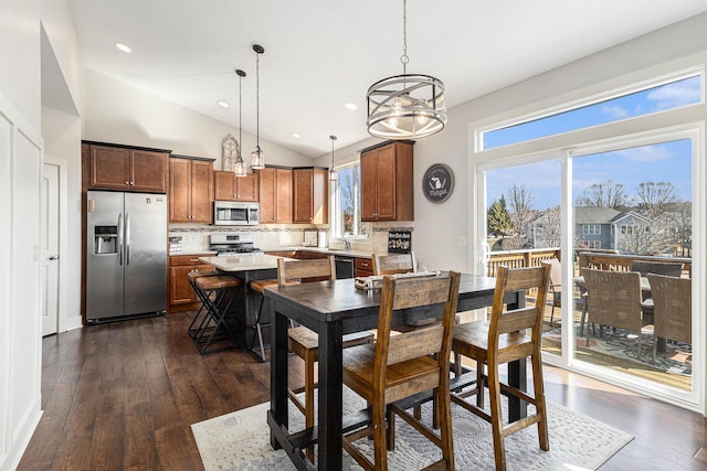 dining area featuring recessed lighting, a chandelier, dark wood finished floors, and vaulted ceiling