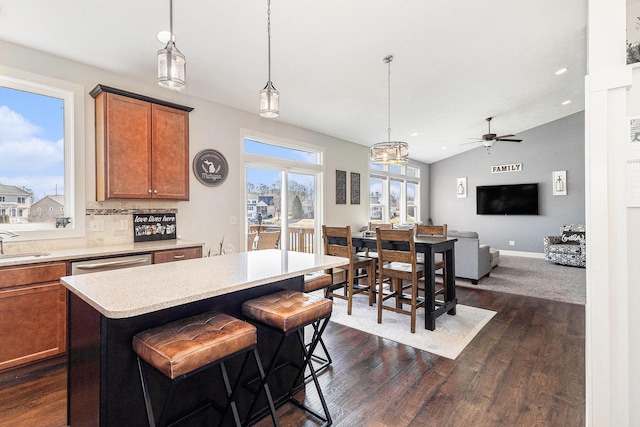 kitchen featuring dark wood finished floors, light countertops, plenty of natural light, and brown cabinets