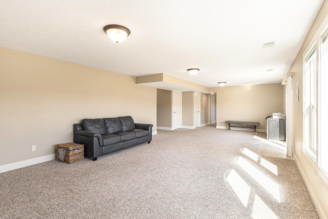 sitting room featuring carpet flooring, baseboards, and visible vents