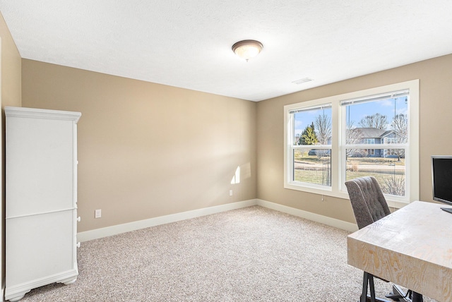 unfurnished office featuring baseboards, carpet floors, and visible vents