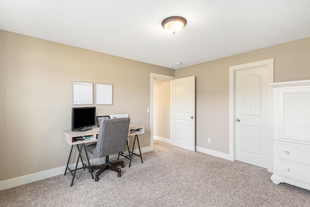 home office featuring baseboards and carpet