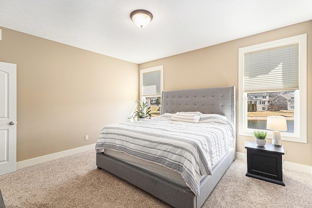 bedroom with baseboards and carpet floors