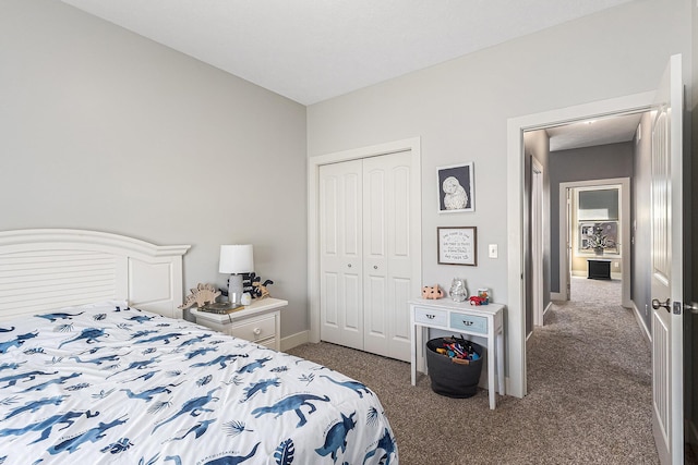 carpeted bedroom with baseboards and a closet