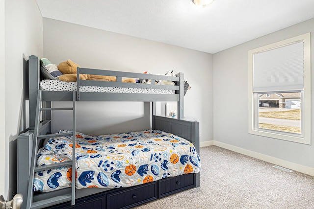 bedroom with visible vents, baseboards, and carpet