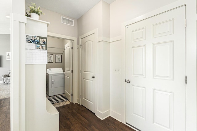 washroom featuring visible vents, washer / dryer, dark wood-style floors, and laundry area