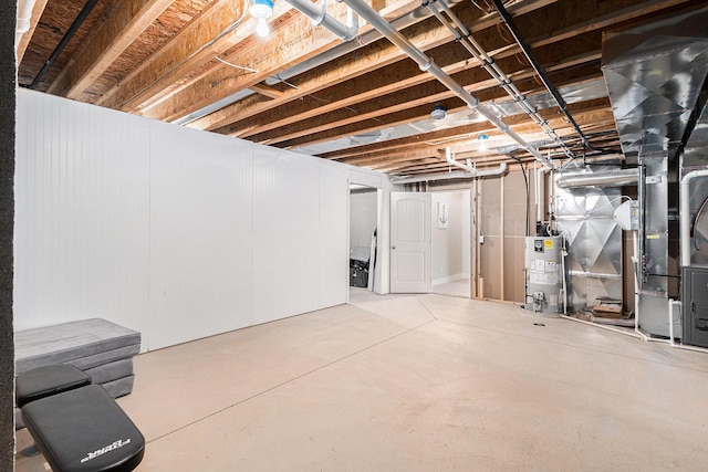 unfinished basement featuring gas water heater and heating unit