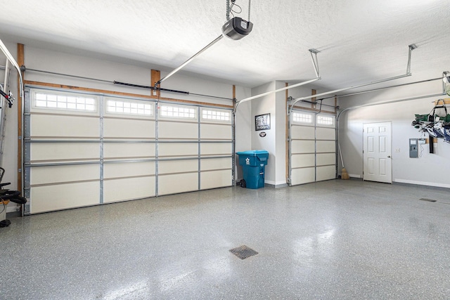 garage with a garage door opener and baseboards