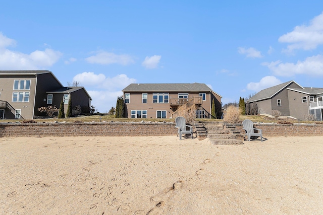 rear view of property featuring stairway