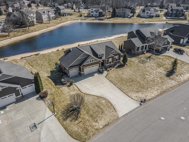 drone / aerial view featuring a residential view and a water view