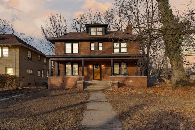 traditional style home with brick siding and a porch