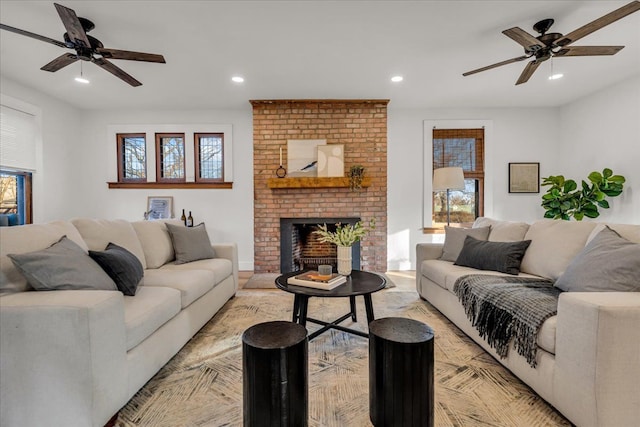 living room featuring recessed lighting, a brick fireplace, and ceiling fan