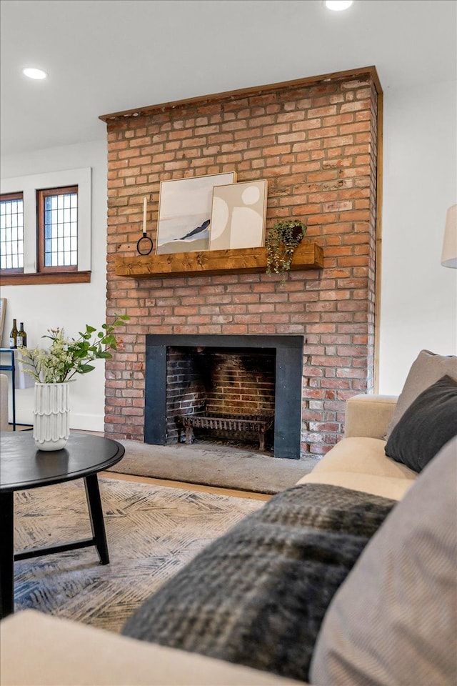 living room with a brick fireplace and recessed lighting