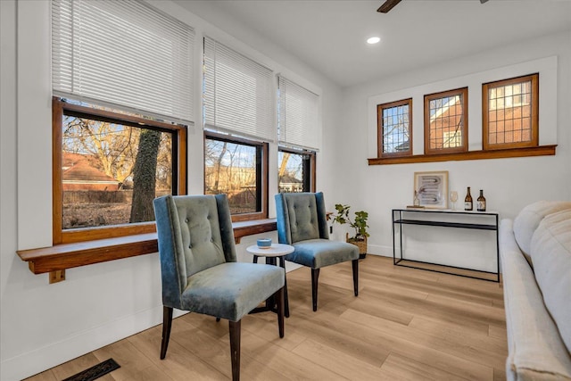 living area featuring recessed lighting, visible vents, baseboards, and light wood-style floors