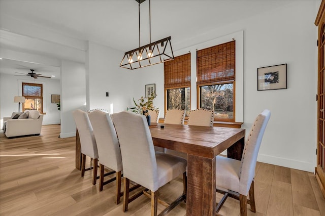 dining area featuring light wood-style floors and baseboards