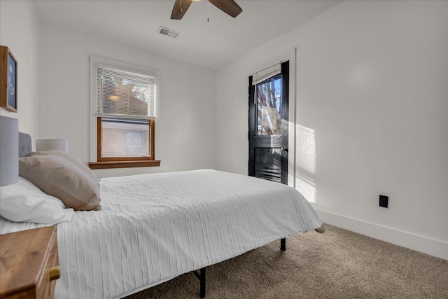 bedroom with carpet flooring, multiple windows, baseboards, and visible vents