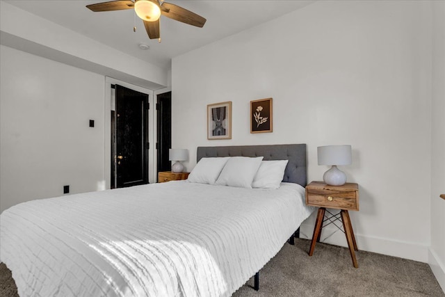 carpeted bedroom featuring a ceiling fan and baseboards