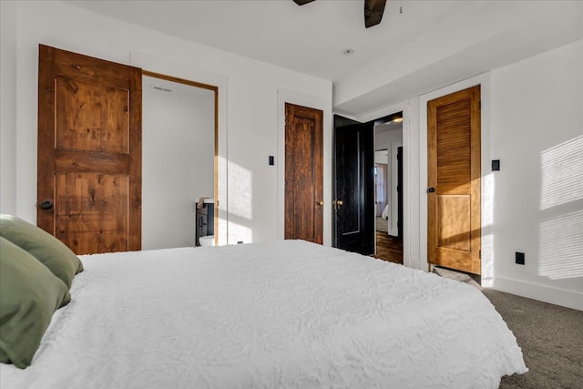 carpeted bedroom featuring ceiling fan, baseboards, and multiple closets