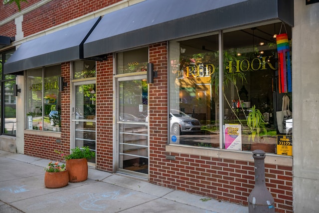 property entrance featuring brick siding