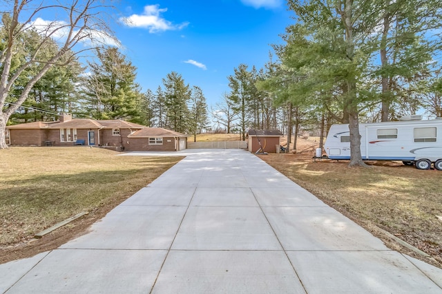 exterior space featuring a storage shed, an outbuilding, and a garage