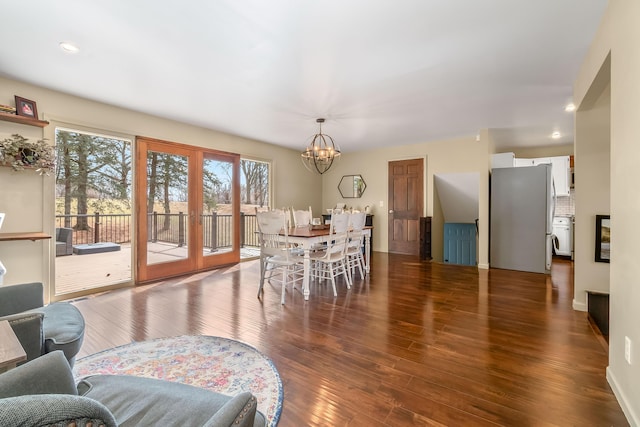 dining area featuring recessed lighting, wood finished floors, french doors, and a chandelier